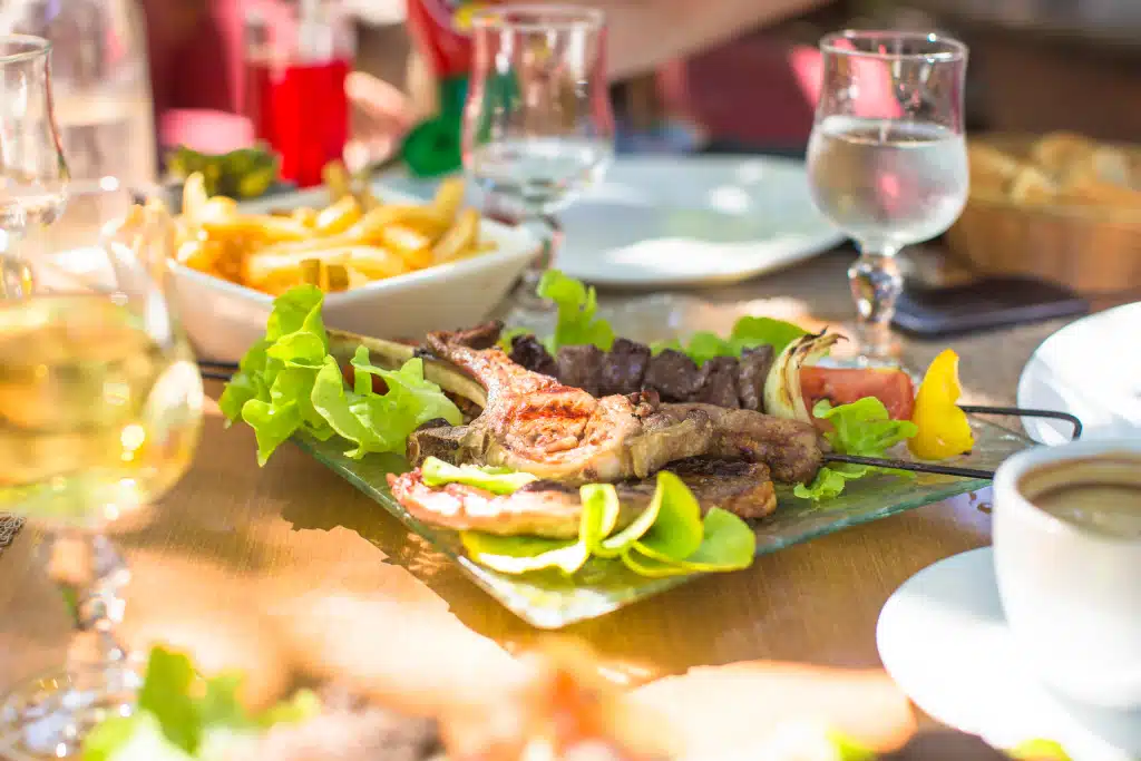 Fresh dinner of salad and meat in outdoor cafe Ramos Pinto High End Relocation Team
